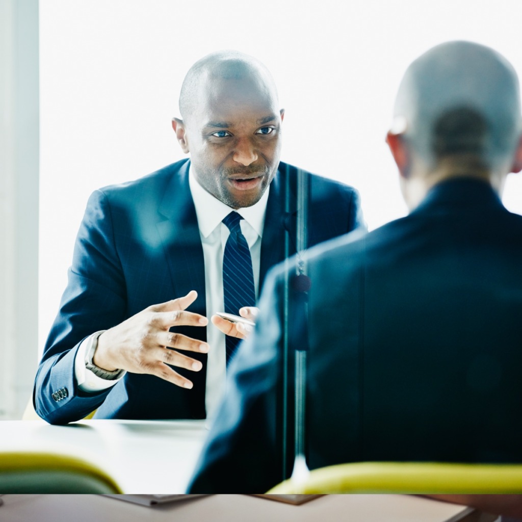 Two men having a face-to-face discussion in the office.